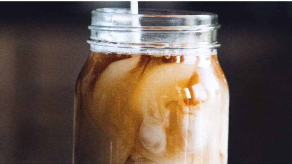 Mason jar of Coffee mixing with milk